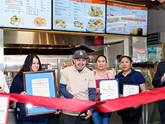 Leticia Roman and Genaro Rodriguez cut the ribbon at the grand opening of their Panorama City to-go/delivery restaurant, 3 Hermanos Kitchen