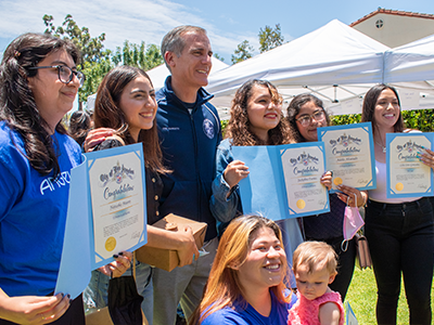 Angeleno Corps program’s first graduating cohort - pictured are four graduates with L.A. Mayor Garcetti on June 29, 2022