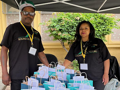 (right to left) Porsche Skinner, CEO of the nonprofit Boundaries Beyond, with John Johnson and at a community service event for Crenshaw Magnet High School