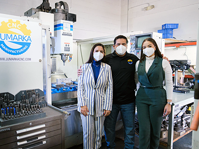 Juan Carlos Hernandez (center) owner of Jumarka CNC Manufacturing, with his wife and daughter (left, right)