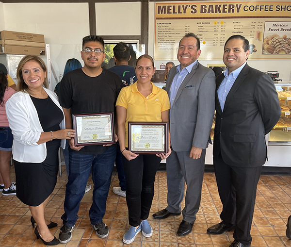 Manuela Dominguez (pictured center, in yellow blouse), owner of Melly’s Bakery located in the Winnetka neighborhood of the Los Angeles San Fernando Valley