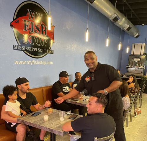 Harris Brown, owner of the LA area My Fish Stop restaurants, serving happy customers at his North Hollywood location
