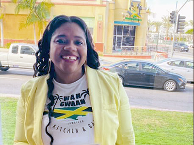 Deandrea Jones, owner of Wah Gwaan Jamaican Restaurant and Bar in Leimert Park, receives her Community Loan from the VSEDC