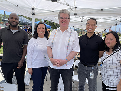 LA City Councilmember Tim McOsker of CD 15 at the Job Resource Fair featured in Juneteenth 400’s annual Juneteenth Celebration (pictured above center with EWDD staff members Aron Thompson and Elisa Lam on the left and Harbor Gateway WSC staff Peter Phou and Jennifer Angeles Weyh on the right)