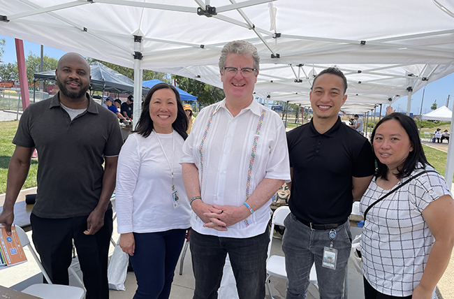 LA City Councilmember Tim McOsker of CD 15 at the Job Resource Fair featured in Juneteenth 400’s annual Juneteenth Celebration (pictured above center with EWDD staff members Aron Thompson and Elisa Lam on the left and Harbor Gateway WSC staff Peter Phou and Jennifer Angeles Weyh on the right)