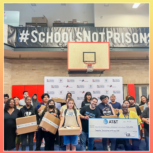 20 South Los Angeles YouthSource Center program graduates in a group showing off their free laptops with internet connectivity and backpacks