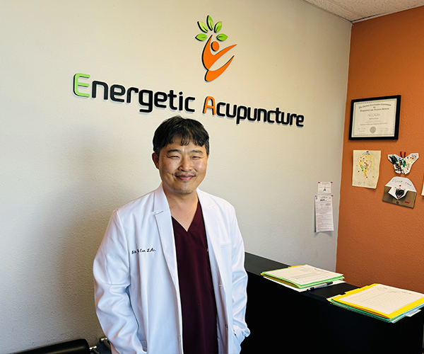 Ick Eom, owner of Energetic Acupuncture Medical Group, stands in his office reception area