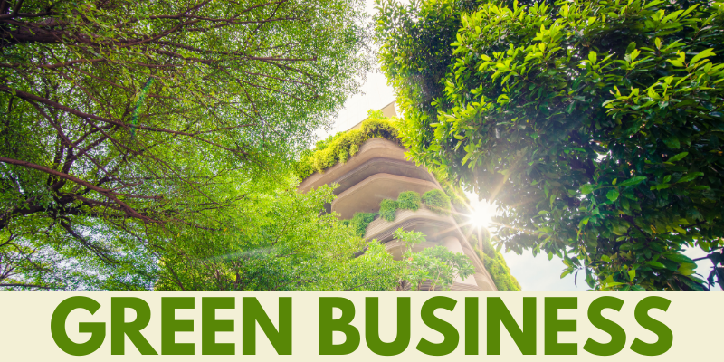 Green Business in LA; photo looking up through green trees at an urban highrise with green plants flourishing from the balconies, along the building's side, and on the roof